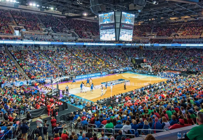 A large crowd watching a basketball game.