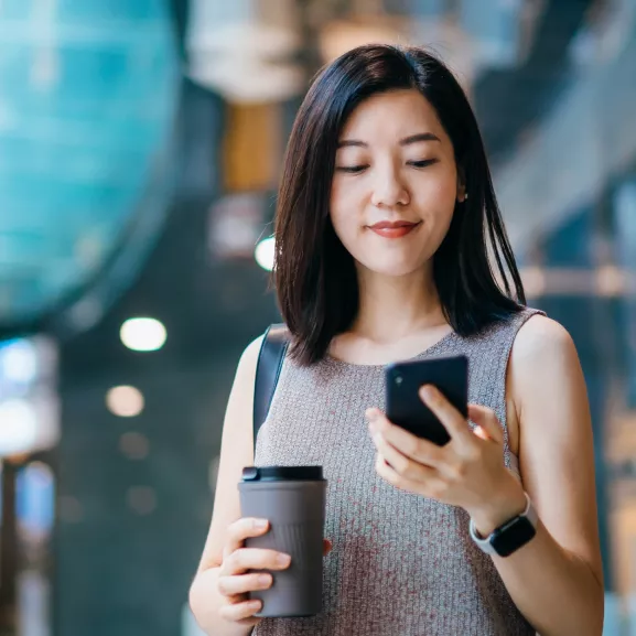 Student with coffee and mobile device