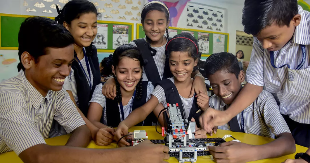 kids working on a science project on a table.