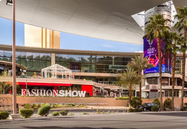 A fashion show sign on a big building.