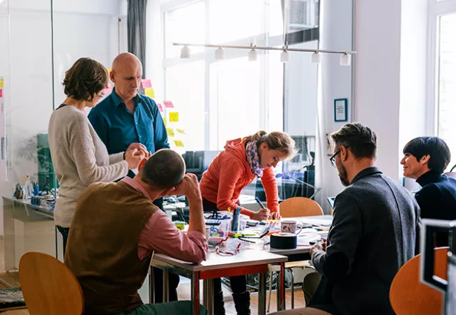 A group of people gathered around a table for a meeting.