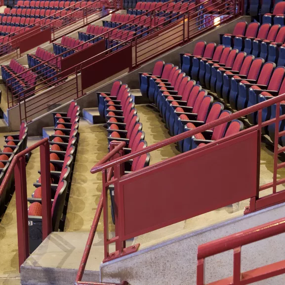 Red and blue stadium seats in the stands.