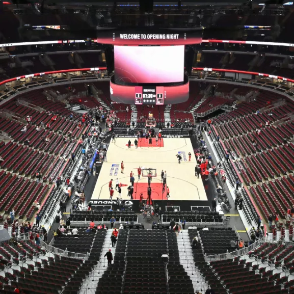 A basketball game being played in an arena.