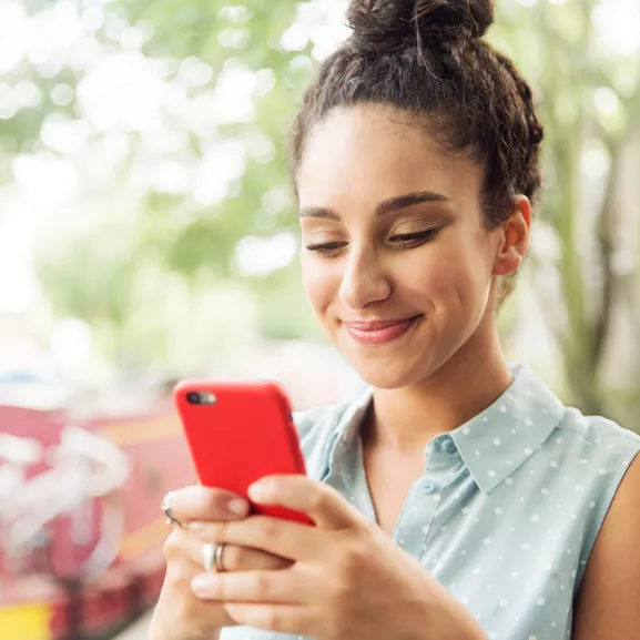 woman using her red cell phone